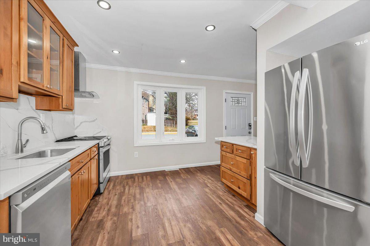 140 Gold Kettle Drive Gaithersburg, MD 20878 - Photo 8 of 35 a kitchen with stainless steel appliances granite countertop a refrigerator a sink dishwasher a stove and white countertops with wooden floor