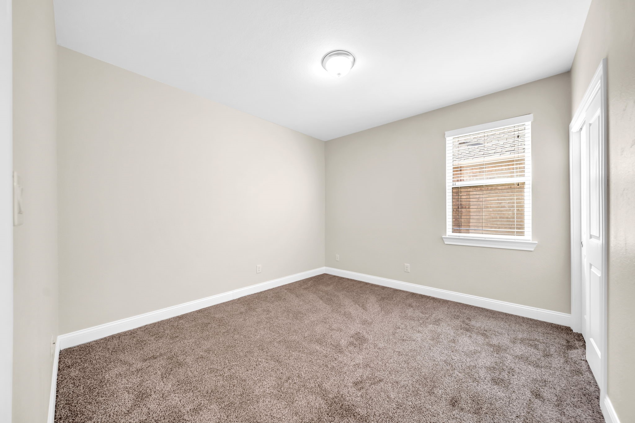19043 Minero Lane Montgomery, TX 77356 - Photo 17 of 26 Secondary bedroom carpeted with window covering.