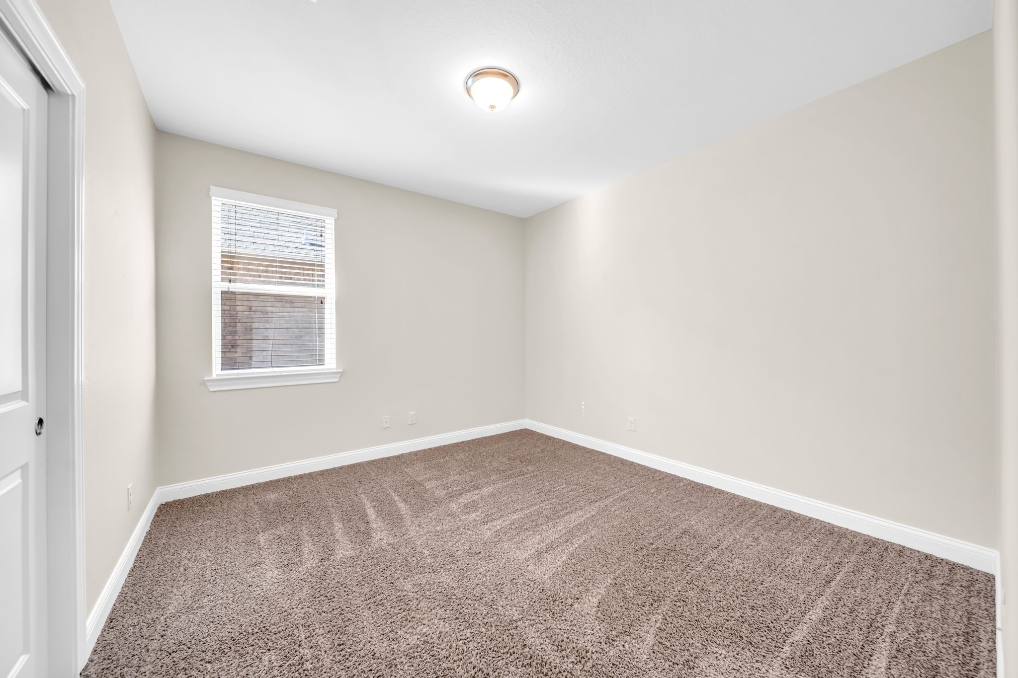 19043 Minero Lane Montgomery, TX 77356 - Photo 18 of 26 Secondary bedroom carpeted with window covering.