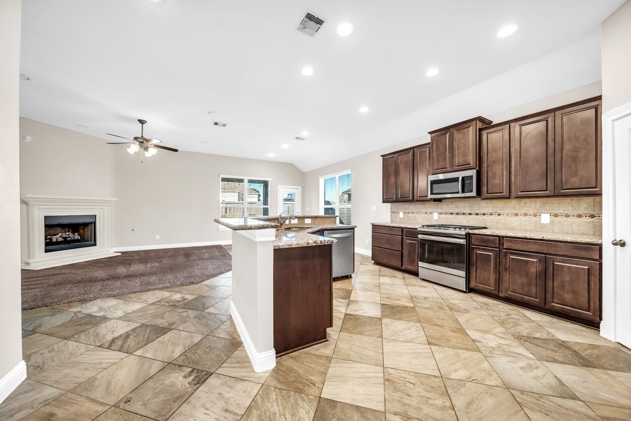 19043 Minero Lane Montgomery, TX 77356 - Photo 4 of 26 Wood cabinets abound with tiled backsplash and granite countertops.