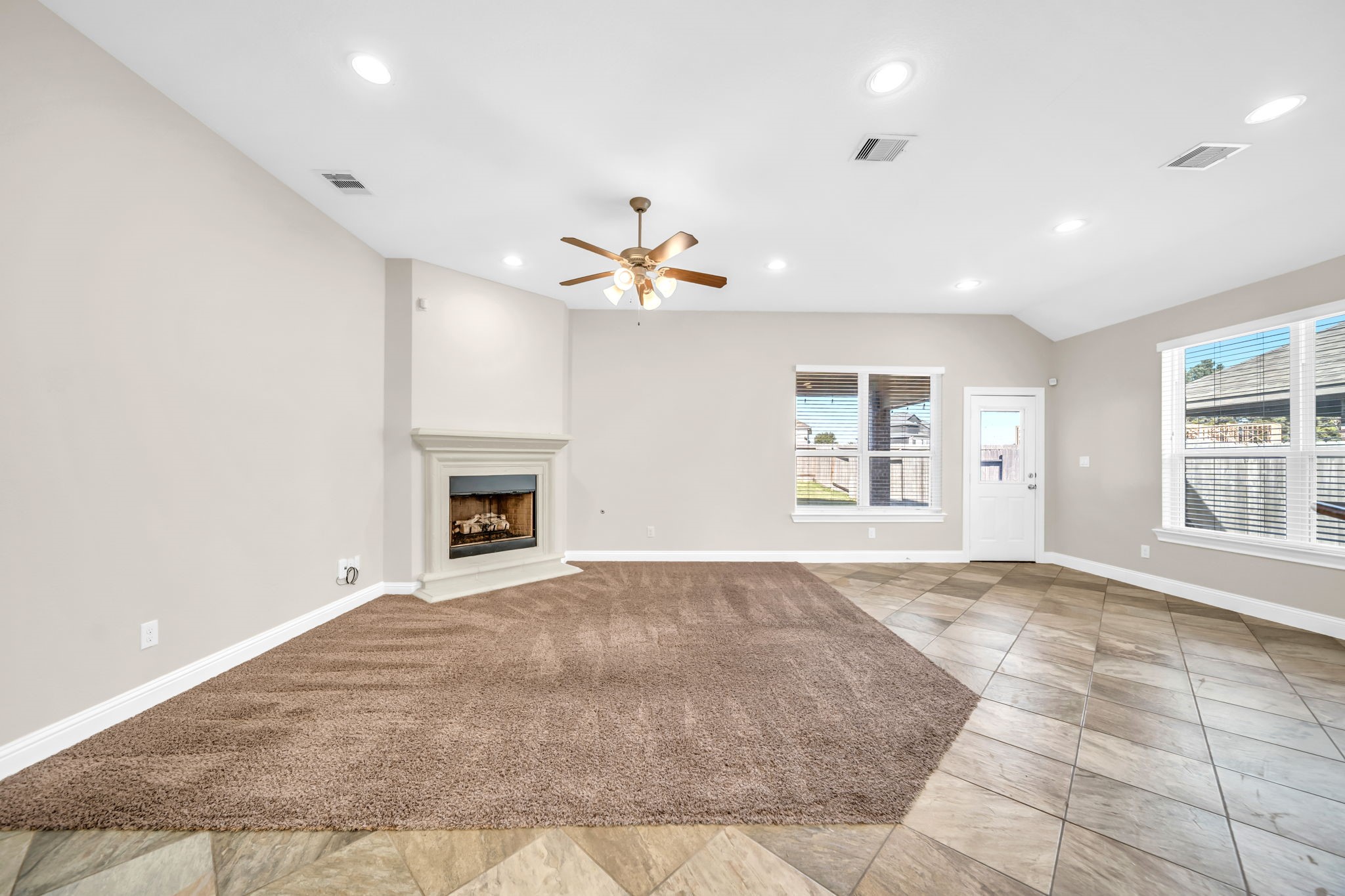 19043 Minero Lane Montgomery, TX 77356 - Photo 9 of 26 Living room is carpeted with ceiling fan.