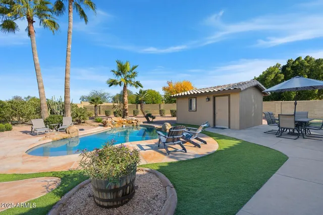 a view of a swimming pool with chairs in patio