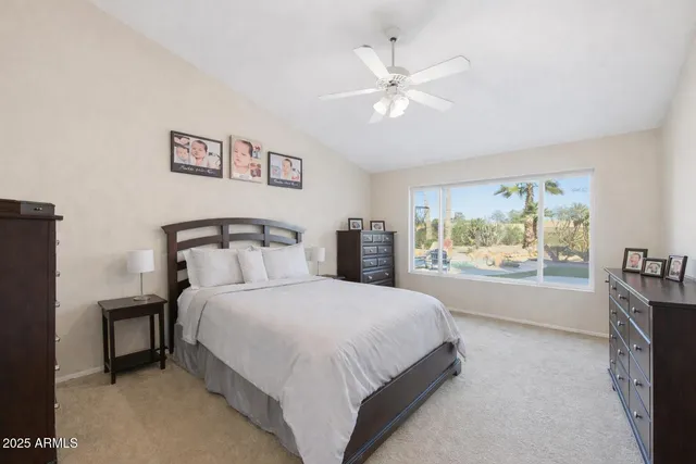 a bedroom with a large bed and a chandelier