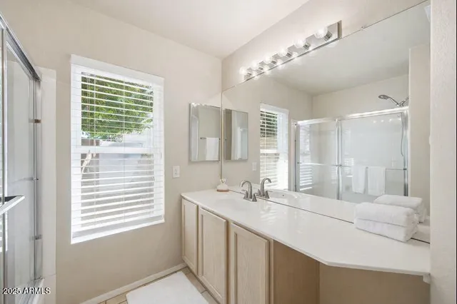 a bathroom with a double vanity sink and a mirror