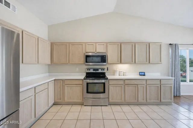 a kitchen with stainless steel appliances a stove sink and cabinets