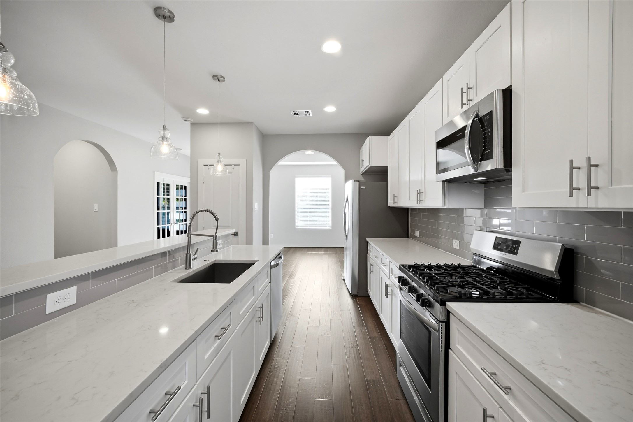 605 Dumble Street Houston, TX 77023 - Photo 1 of 44 a kitchen with stainless steel appliances a sink a stove top oven a counter space and cabinets
