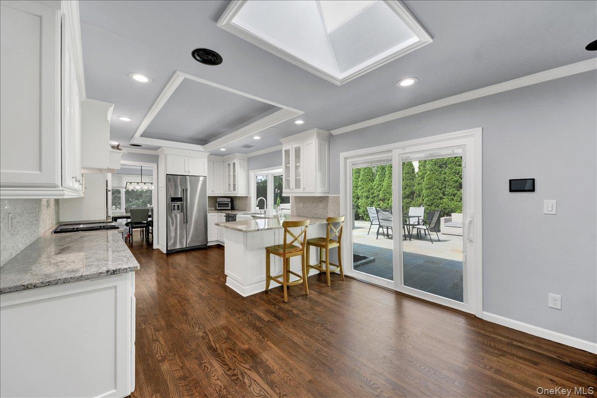 2 Stonycrest Road West Harrison, NY 10604 - Photo 11 of 30 Eat-in Kitchen with granite countertops and sliding doors that lead to backyard