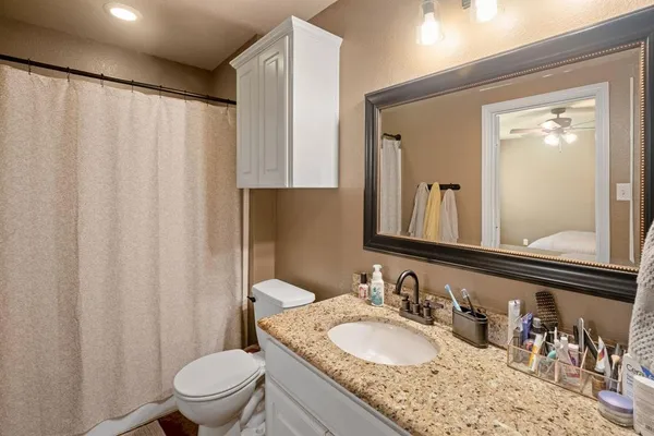 a bedroom with a bed and teddy bear on the dresser