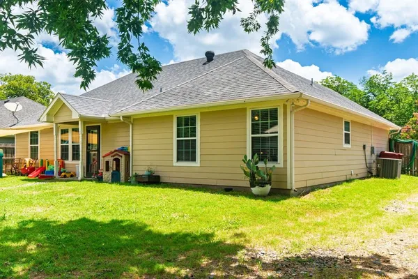 a view of a house with a yard and sitting area