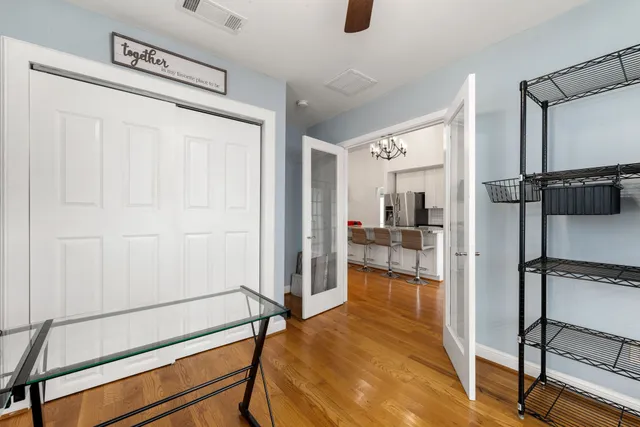 a workspace with wooden floor and a window