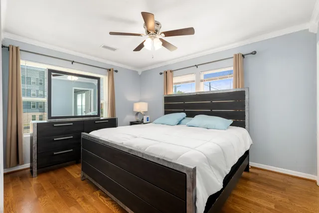 a bedroom with a bed and wooden floor
