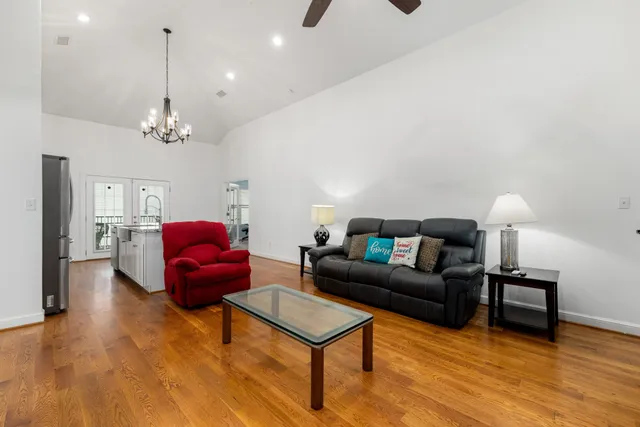 a living room with furniture a rug and a chandelier