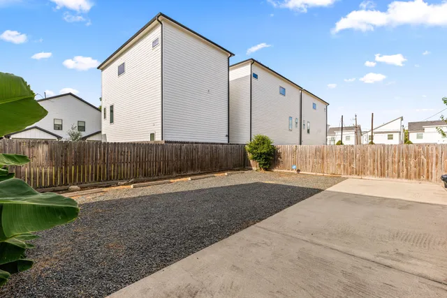 a view of a house with wooden fence