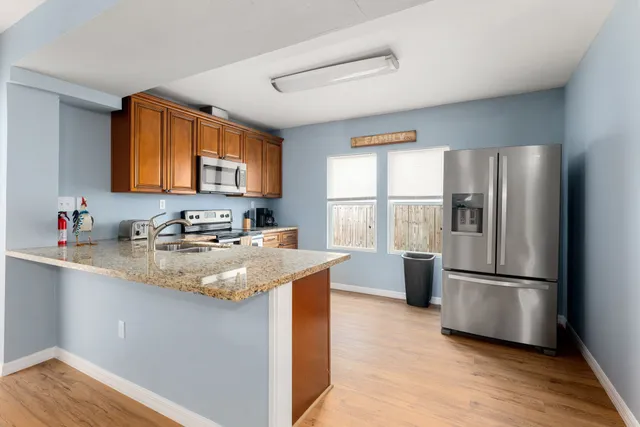 a kitchen with a sink a stove and cabinets