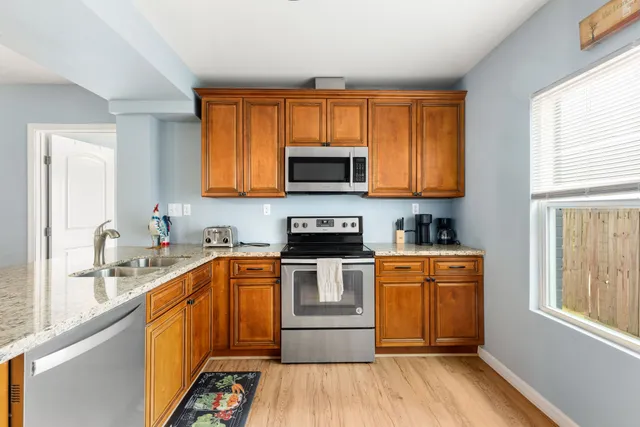 a kitchen with stainless steel appliances granite countertop a sink and cabinets