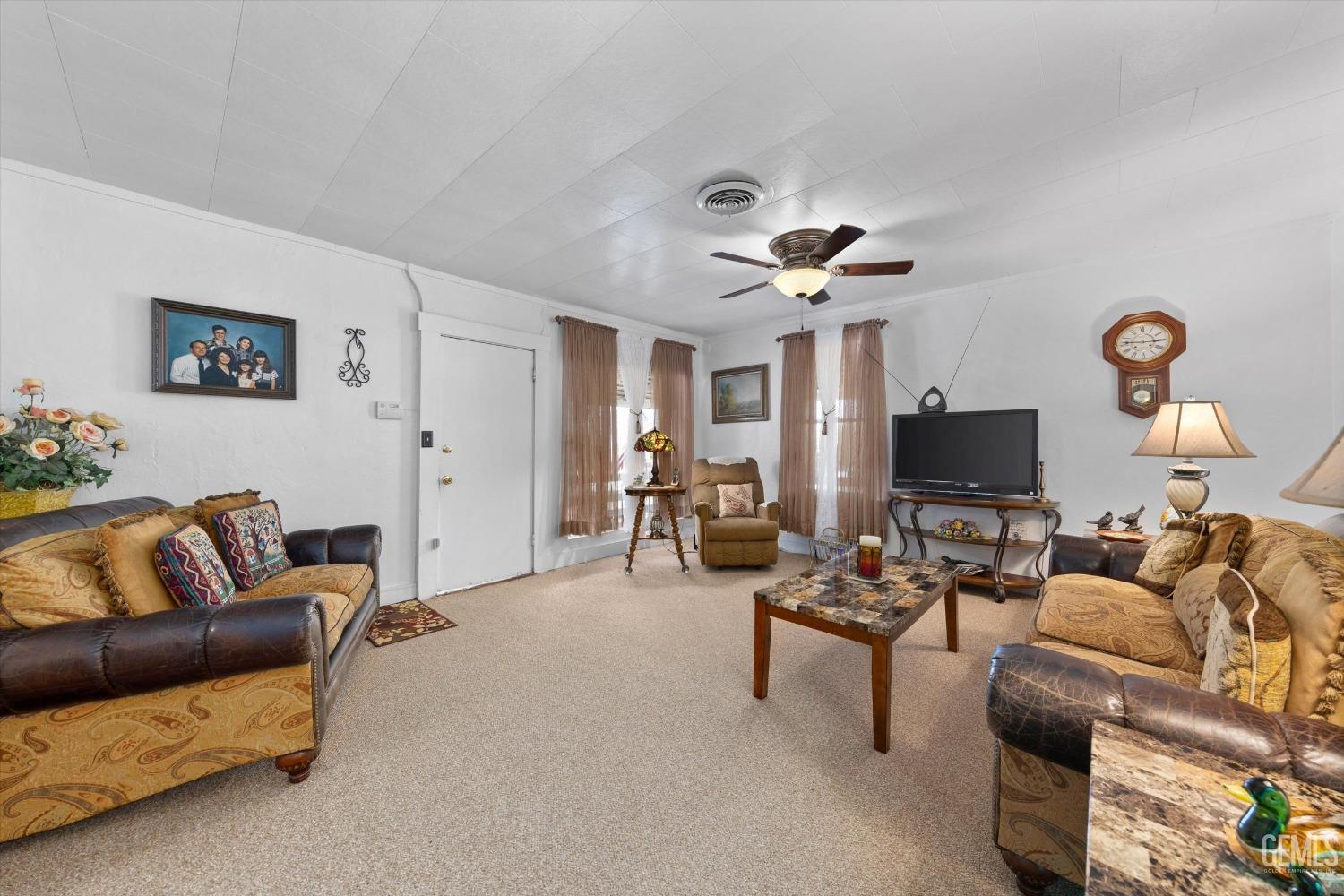 Undisclosed Address Taft, CA 93268 - Photo 13 of 44 a living room with furniture and a flat screen tv