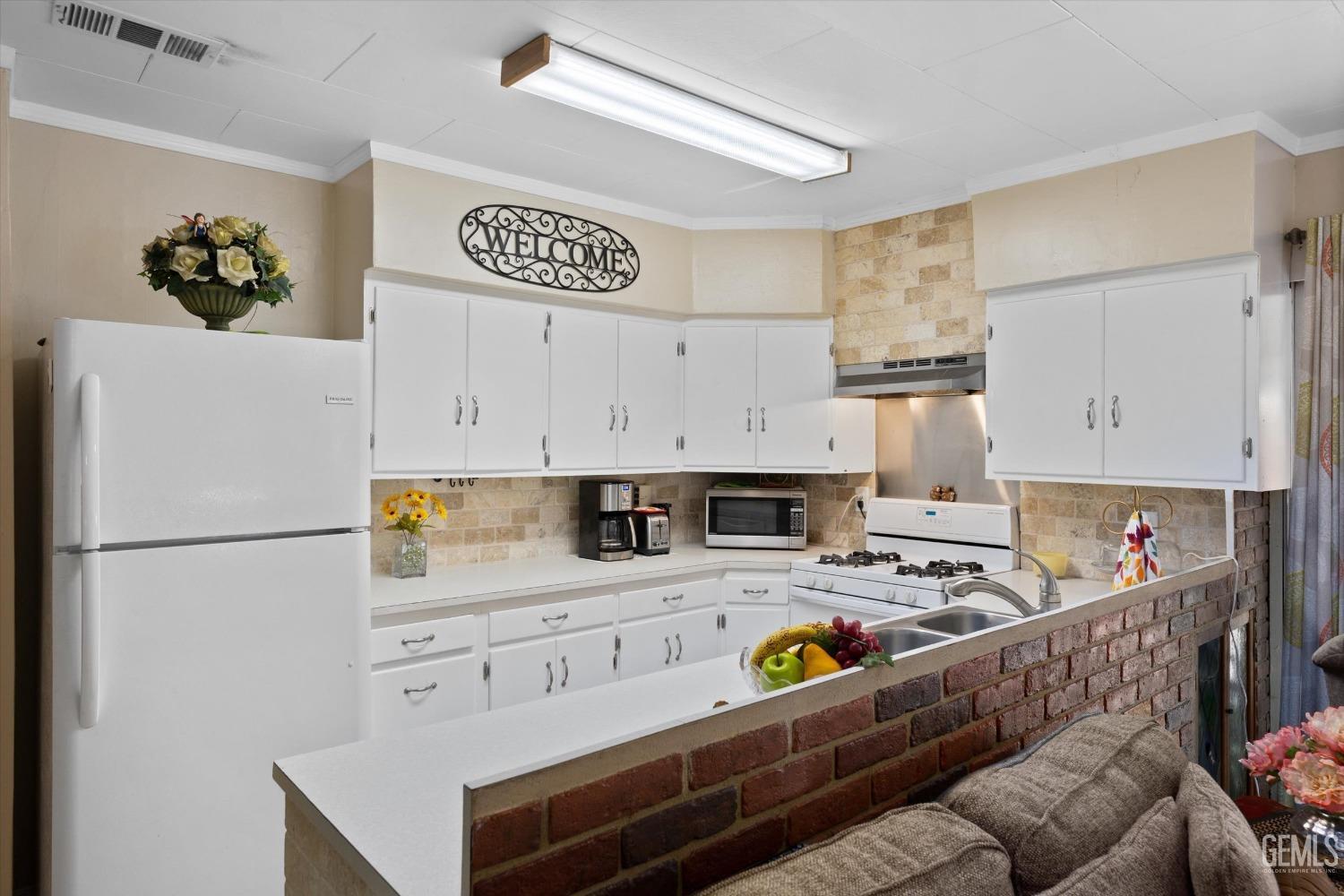 Undisclosed Address Taft, CA 93268 - Photo 22 of 44 a kitchen with stainless steel appliances granite countertop a refrigerator sink stove and white cabinets