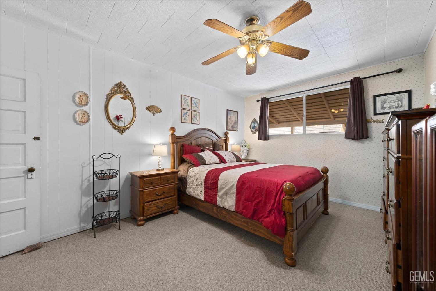 Undisclosed Address Taft, CA 93268 - Photo 31 of 44 a spacious bedroom with a bed next to a window and a bookshelf