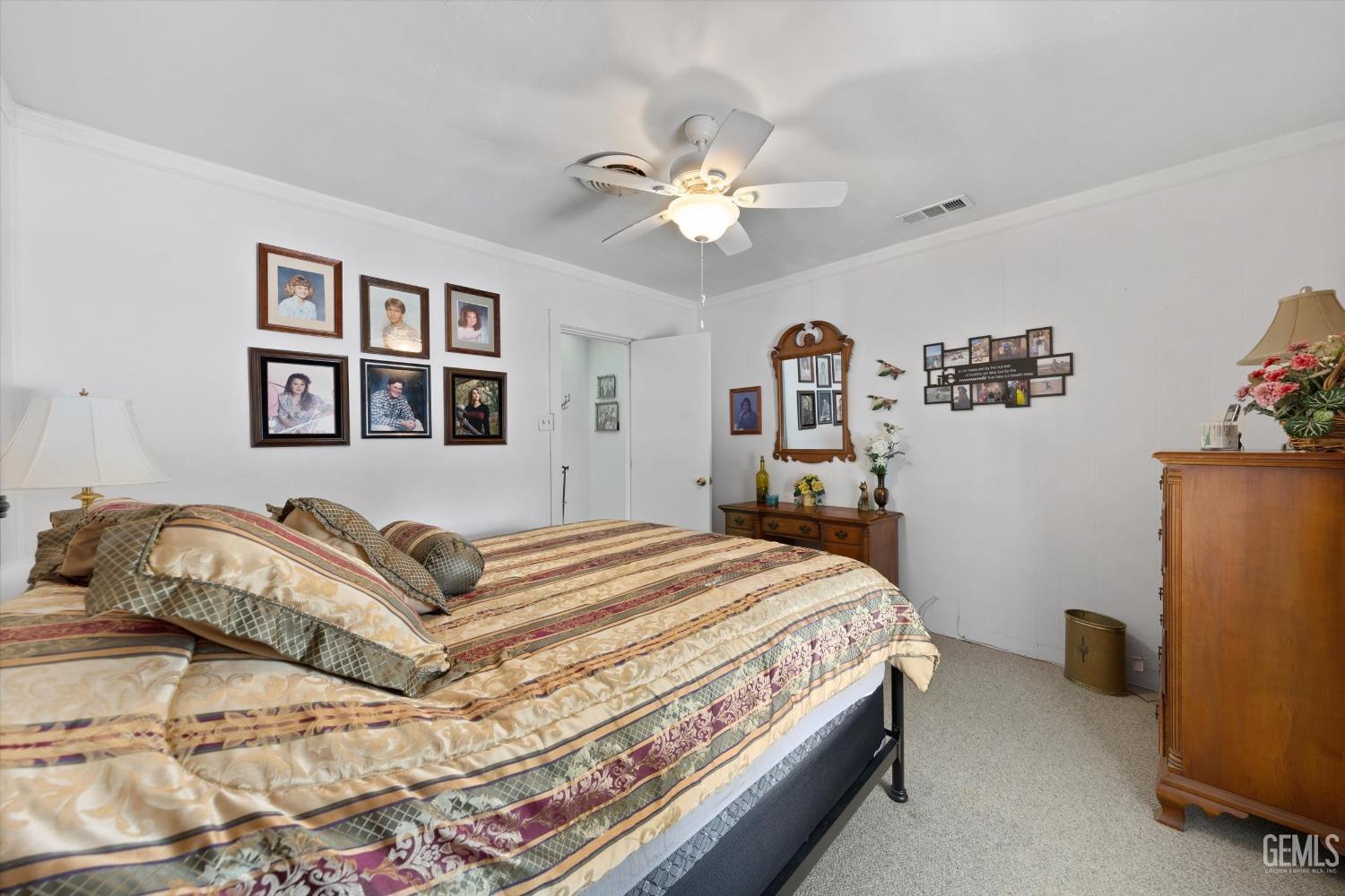 Undisclosed Address Taft, CA 93268 - Photo 35 of 44 a bedroom with a large bed and a chandelier