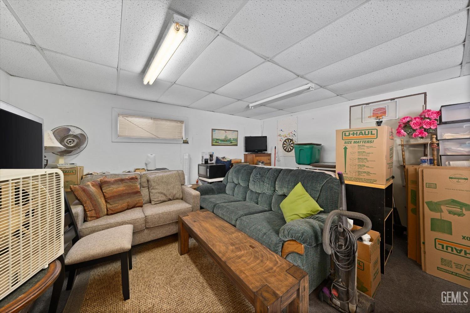 Undisclosed Address Taft, CA 93268 - Photo 36 of 44 a living room with furniture a rug and a chandelier