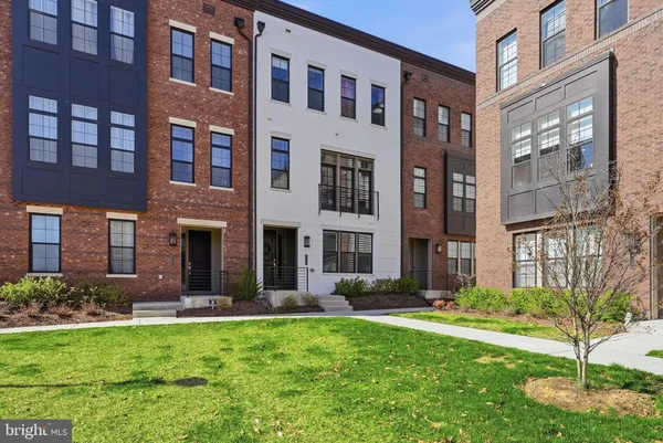 a view of a building with a yard and plants