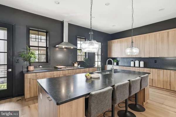 a kitchen with refrigerator and chairs