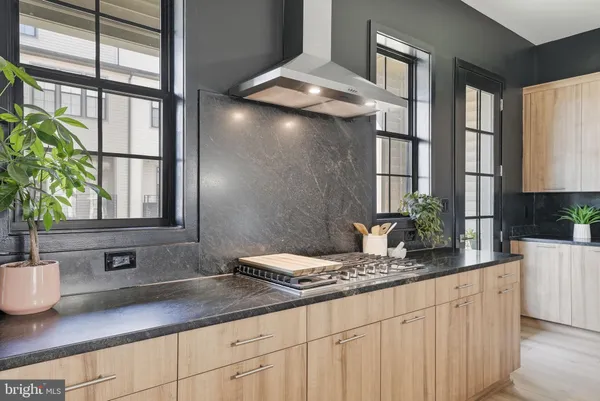 a kitchen with stainless steel appliances a sink a counter top space and a window