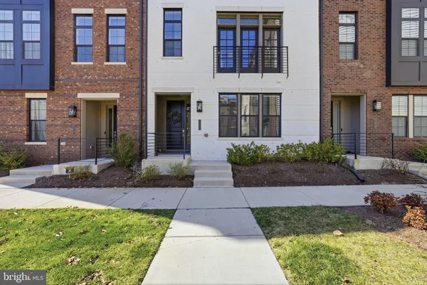 a front view of a brick house with a yard