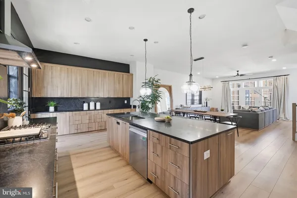 a kitchen with white cabinets a sink and dishwasher
