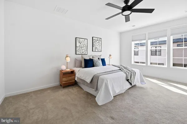 a bed room with bed and windows