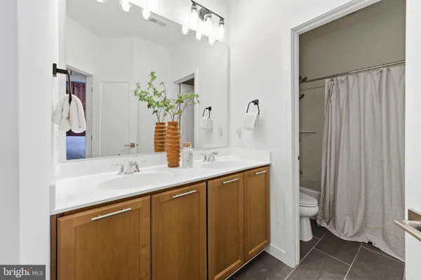 a bedroom with a bed workspace and window