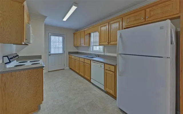a kitchen with stainless steel appliances a refrigerator sink and cabinets