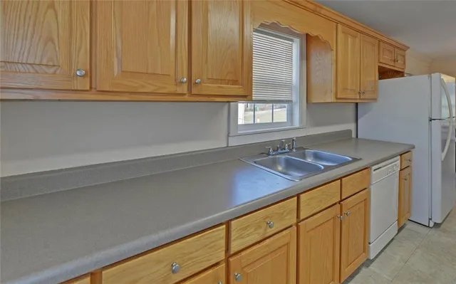 a kitchen with stainless steel appliances granite countertop a sink and a white cabinets