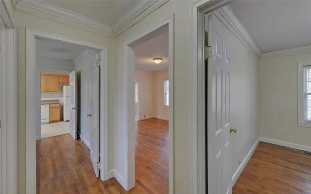 a view of a hallway with wooden floor and closet