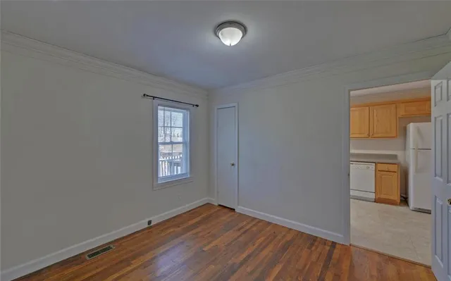 an empty room with windows and closet