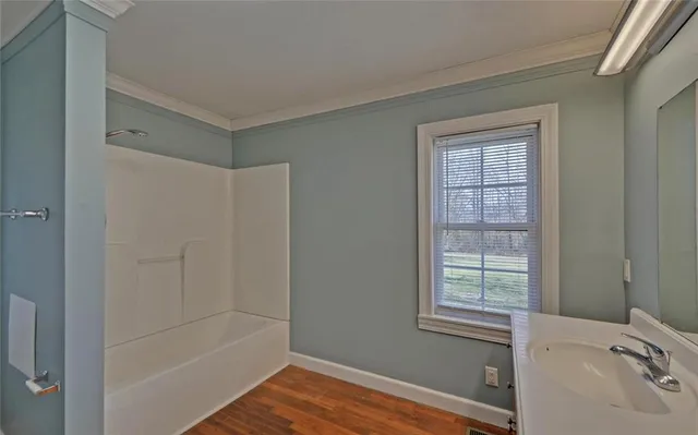 a bathroom with a tub and a sink