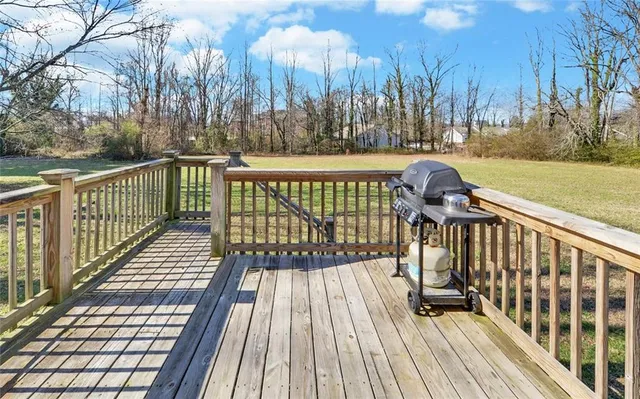 a view of balcony with wooden floor and fence