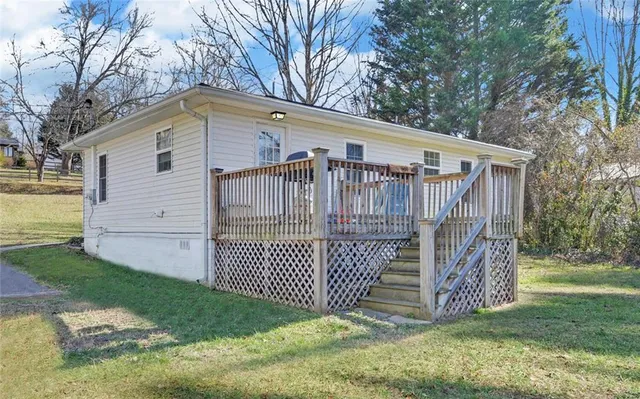 a white house that has tree in front of it