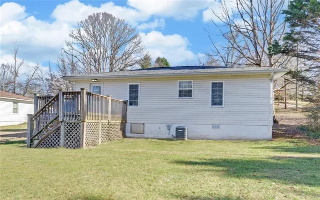 a view of a house with a yard and tree