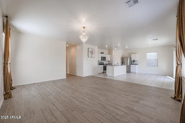a view of kitchen and hall with wooden floor