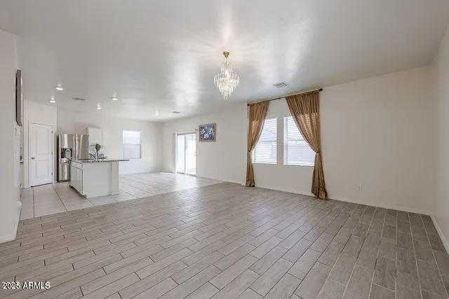 a view of kitchen and hall with wooden floor