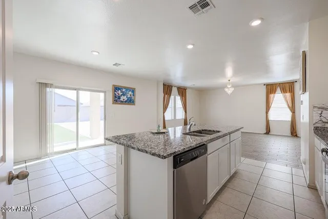 a kitchen with granite countertop a sink and a stove
