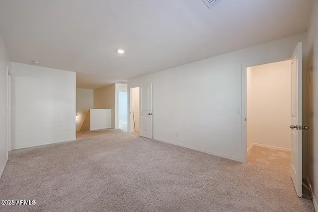 a view of an empty room and a window