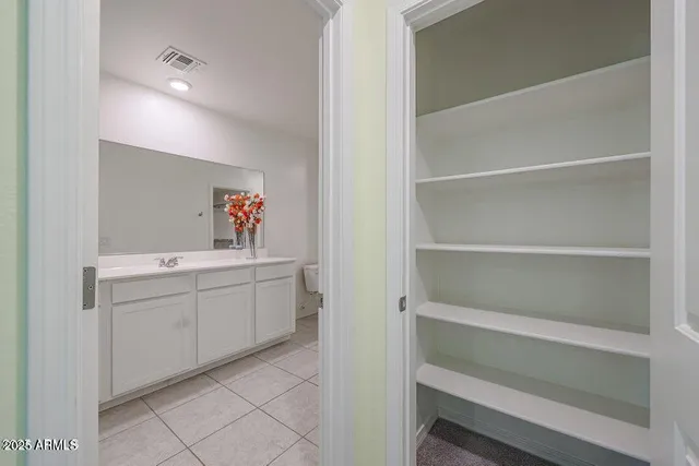 a bathroom with a glass shower door and a sink