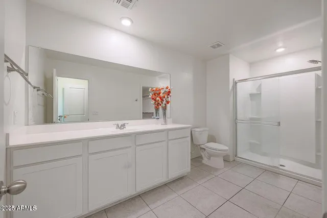 a bathroom with a shower a toilet and sink