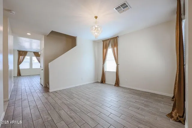 a view of a room with wooden floor and staircase