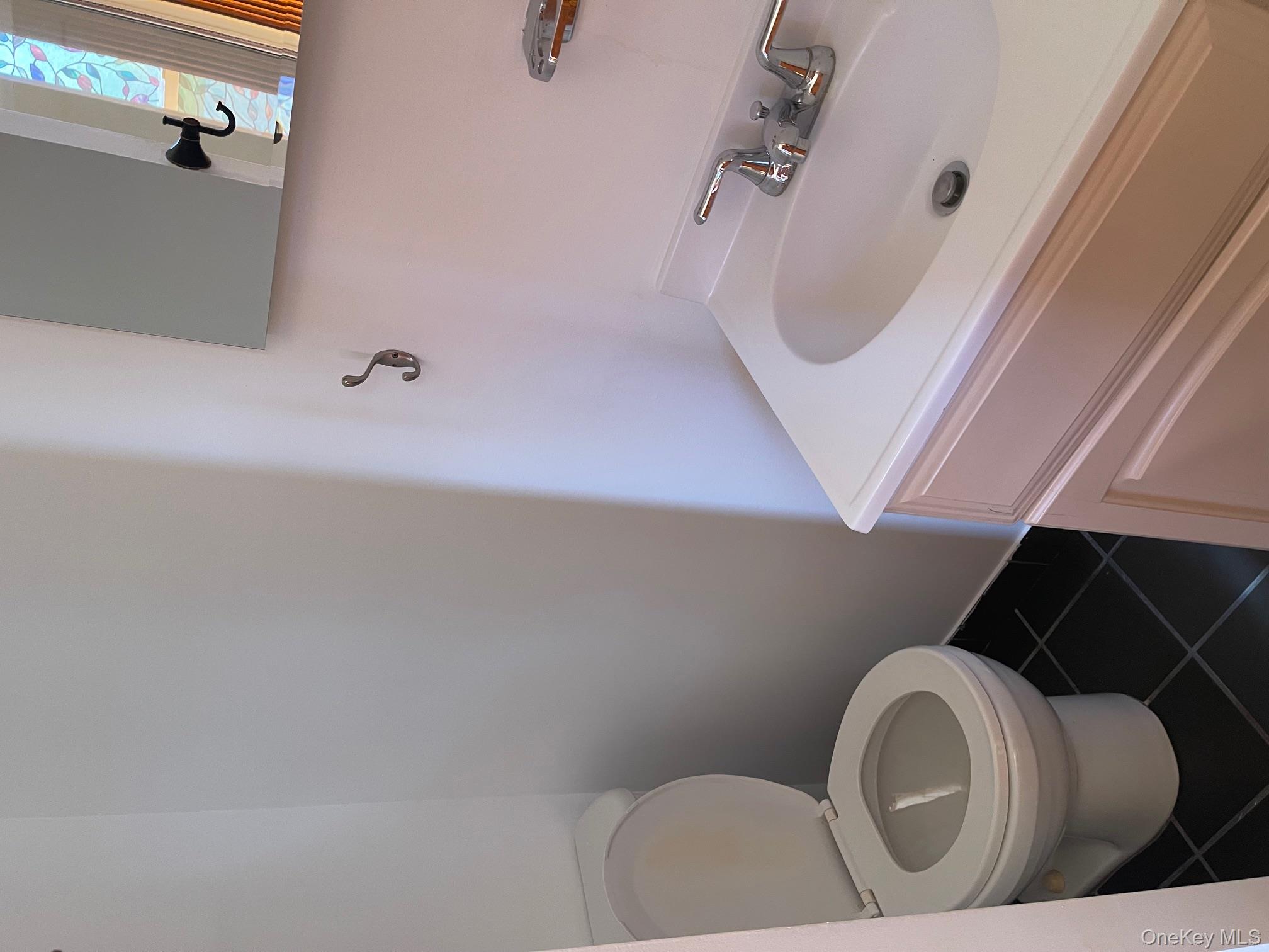 57 Ashland Street, Unit 2 New Rochelle, NY 10801 - Photo 14 of 19 Bathroom with dark tile patterned flooring and vanity