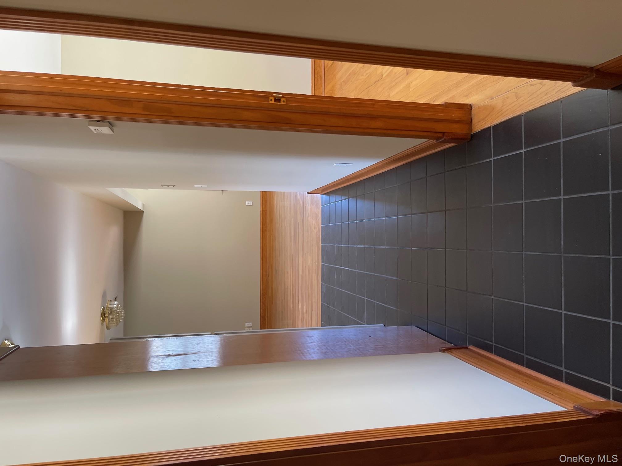 57 Ashland Street, Unit 2 New Rochelle, NY 10801 - Photo 17 of 19 Corridor featuring dark tile patterned flooring and baseboards