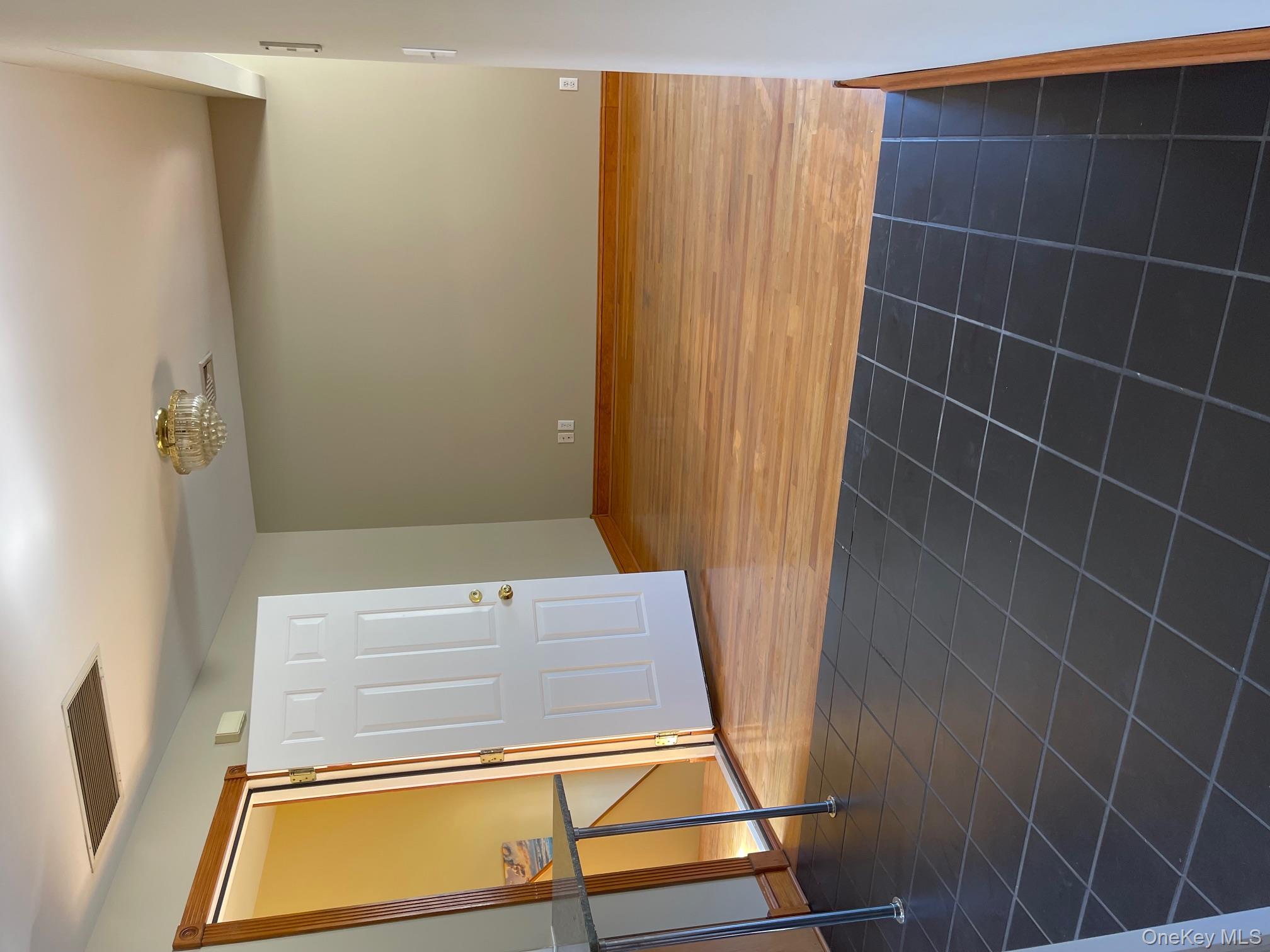 57 Ashland Street, Unit 2 New Rochelle, NY 10801 - Photo 19 of 19 Empty room featuring dark tile patterned flooring and a chandelier