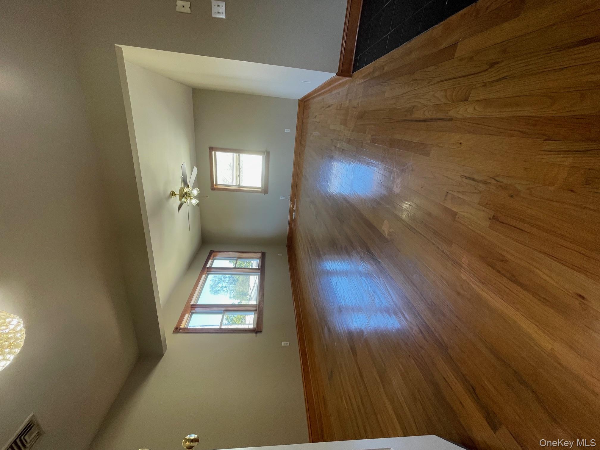 57 Ashland Street, Unit 2 New Rochelle, NY 10801 - Photo 2 of 19 Spare room with dark wood-type flooring and ceiling fan
